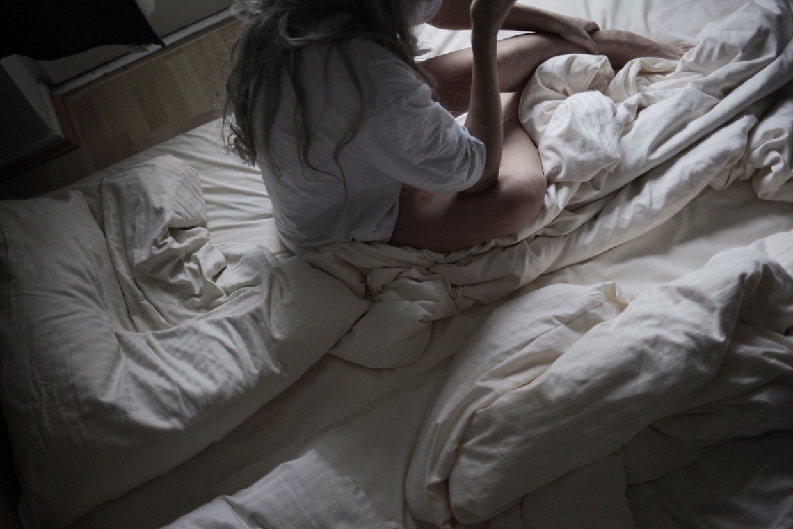 girl waking up in crumpled sheets