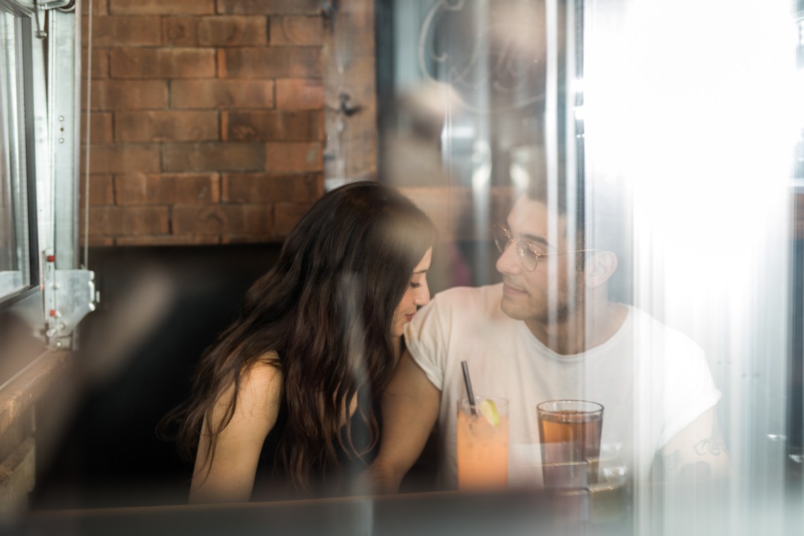 couple looking close at bar