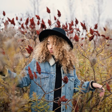 Lovely Lady Captivated by the Magnificence of Red Flowers