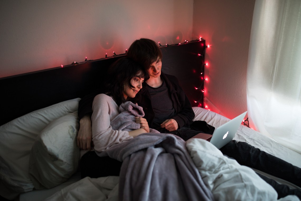 A lazy girl in bed with her boyfriend