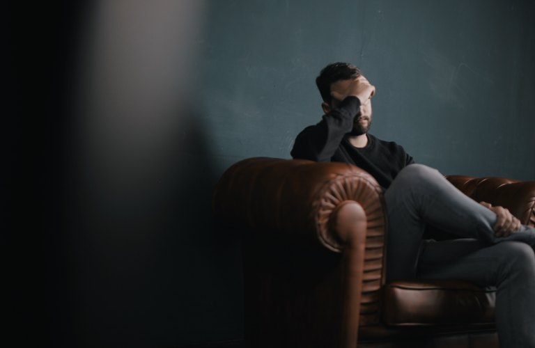 sad guy sitting on couch