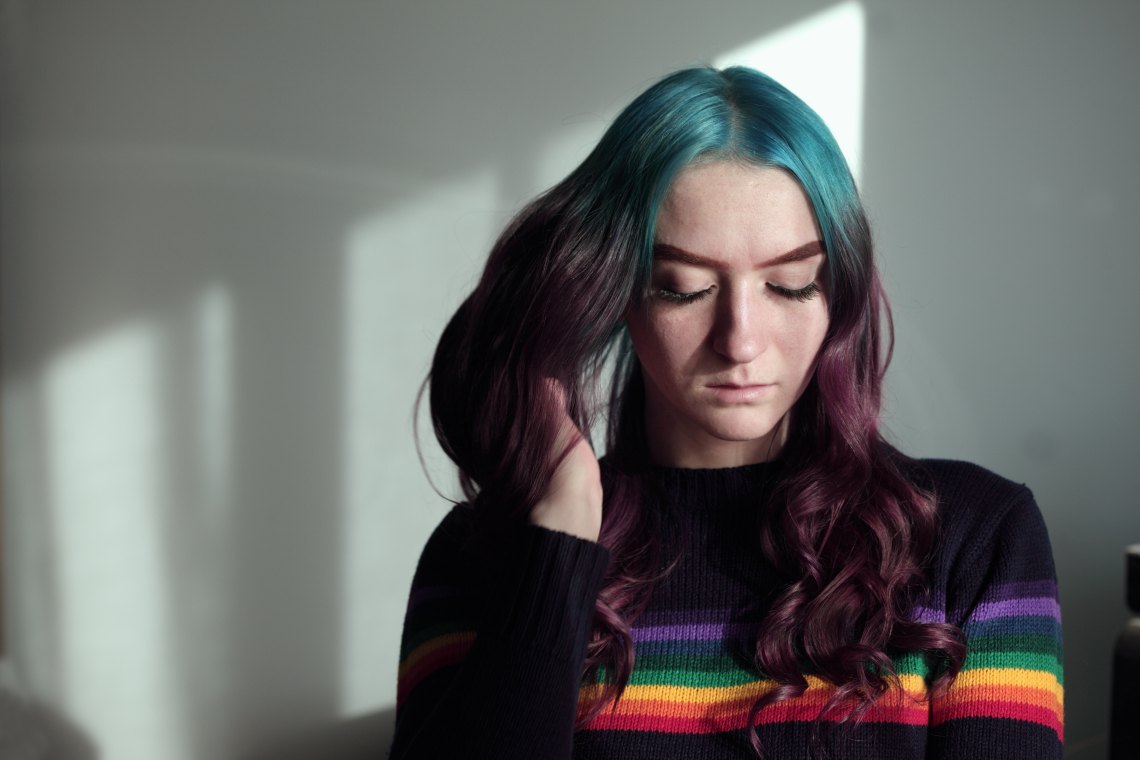 girl rainbow sweater face