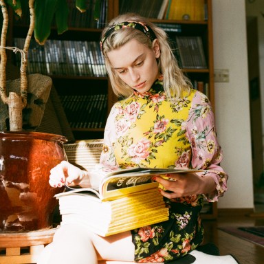 woman reading a ton of magazines