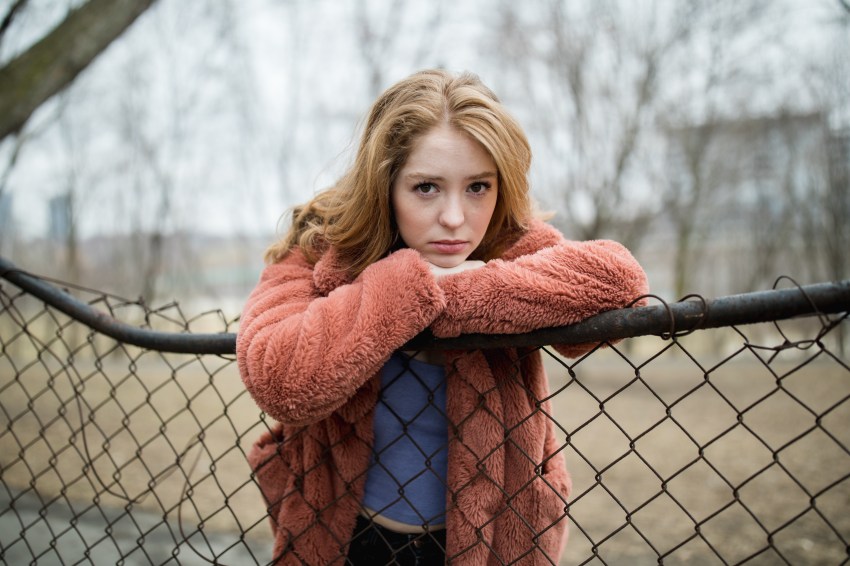 woman upset leaning on fence