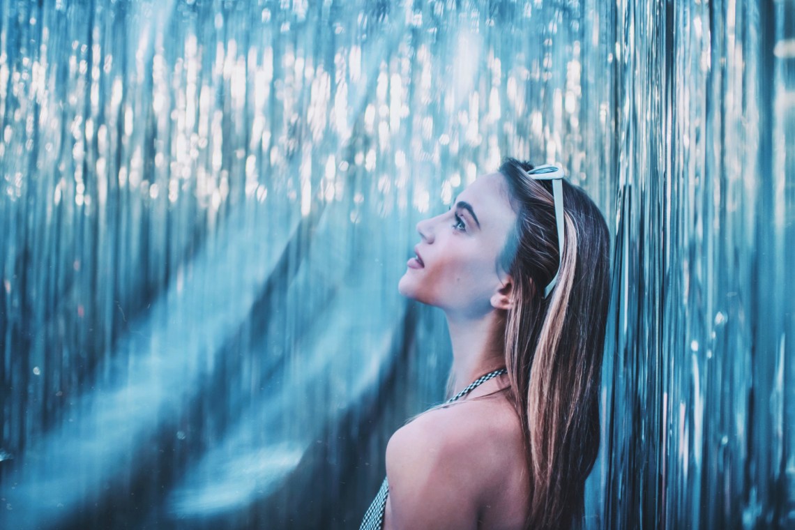woman standing in blue and glittering room