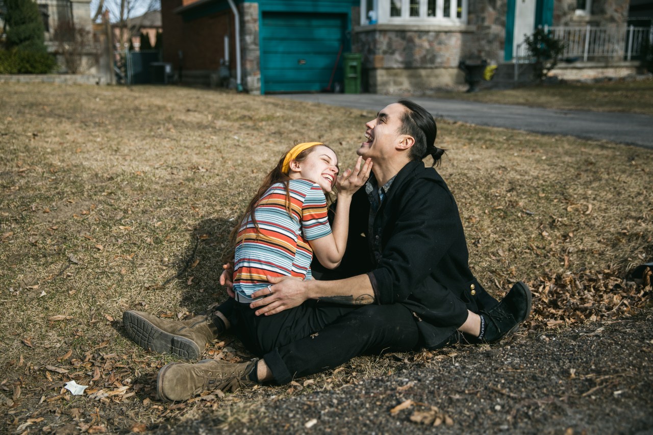 couple laughing on grass