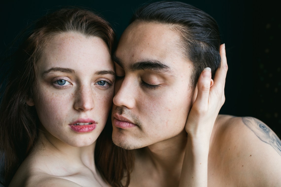 woman holding man's head lovingly
