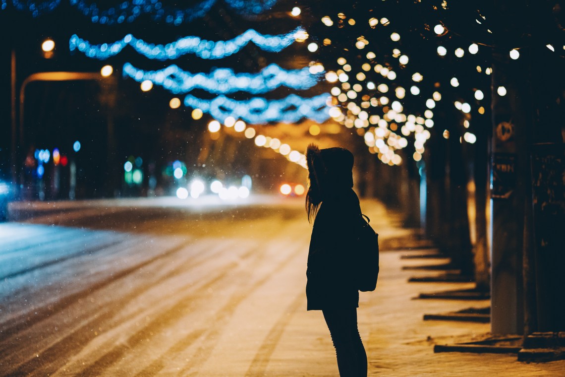 woman standing alone on cold night