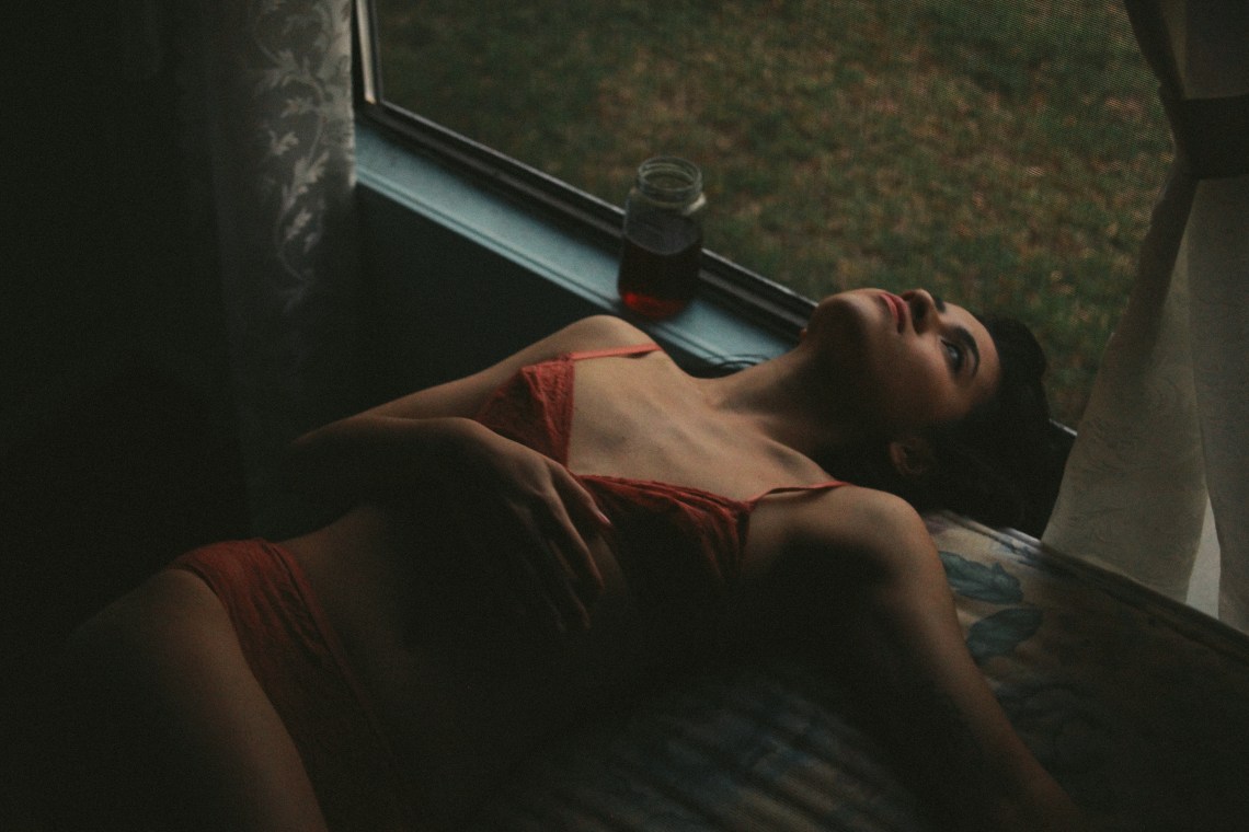 woman laying in orange bra