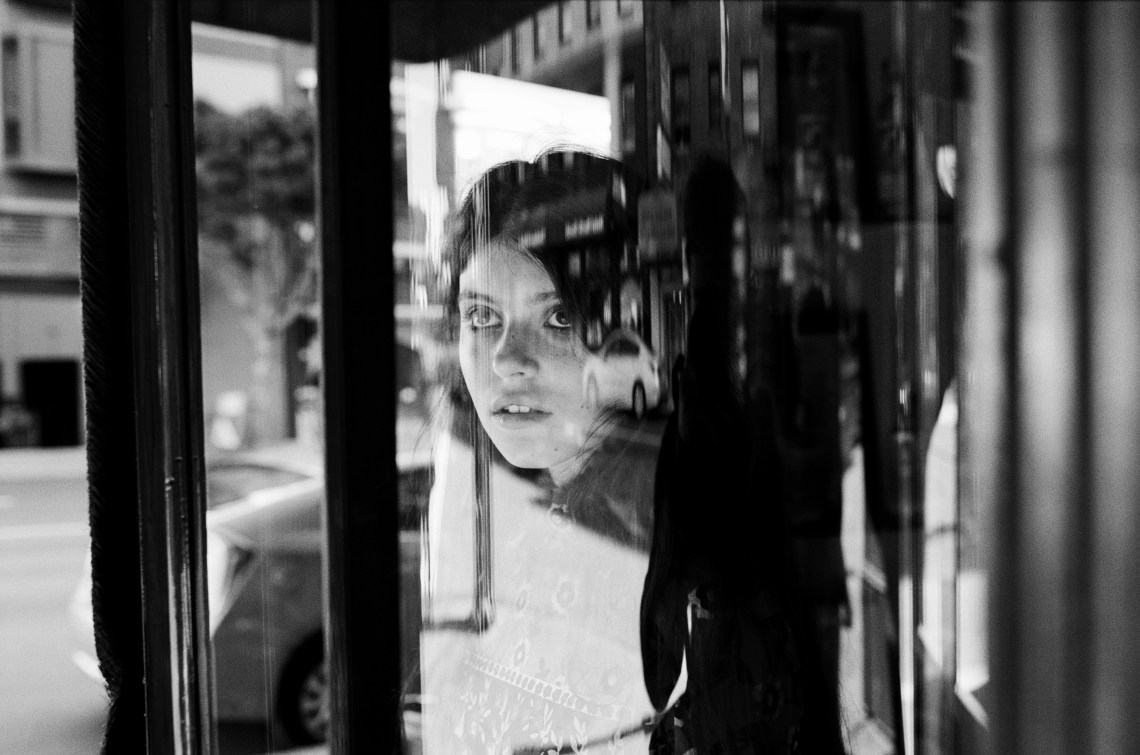 woman staring out window in black and white
