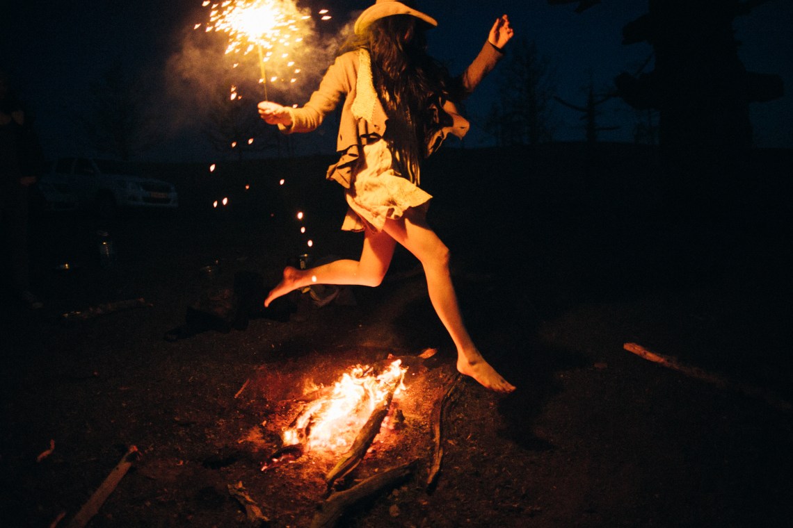 woman jumping over fire