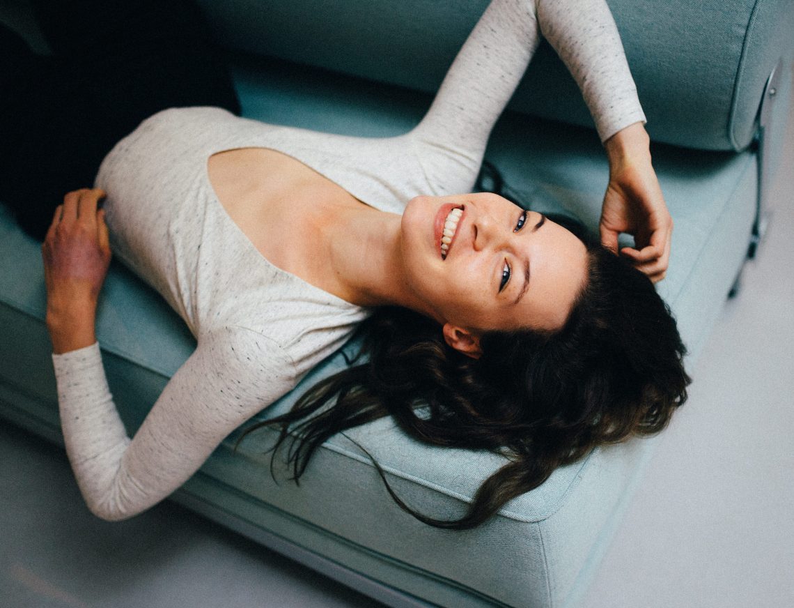 woman laying down on couch