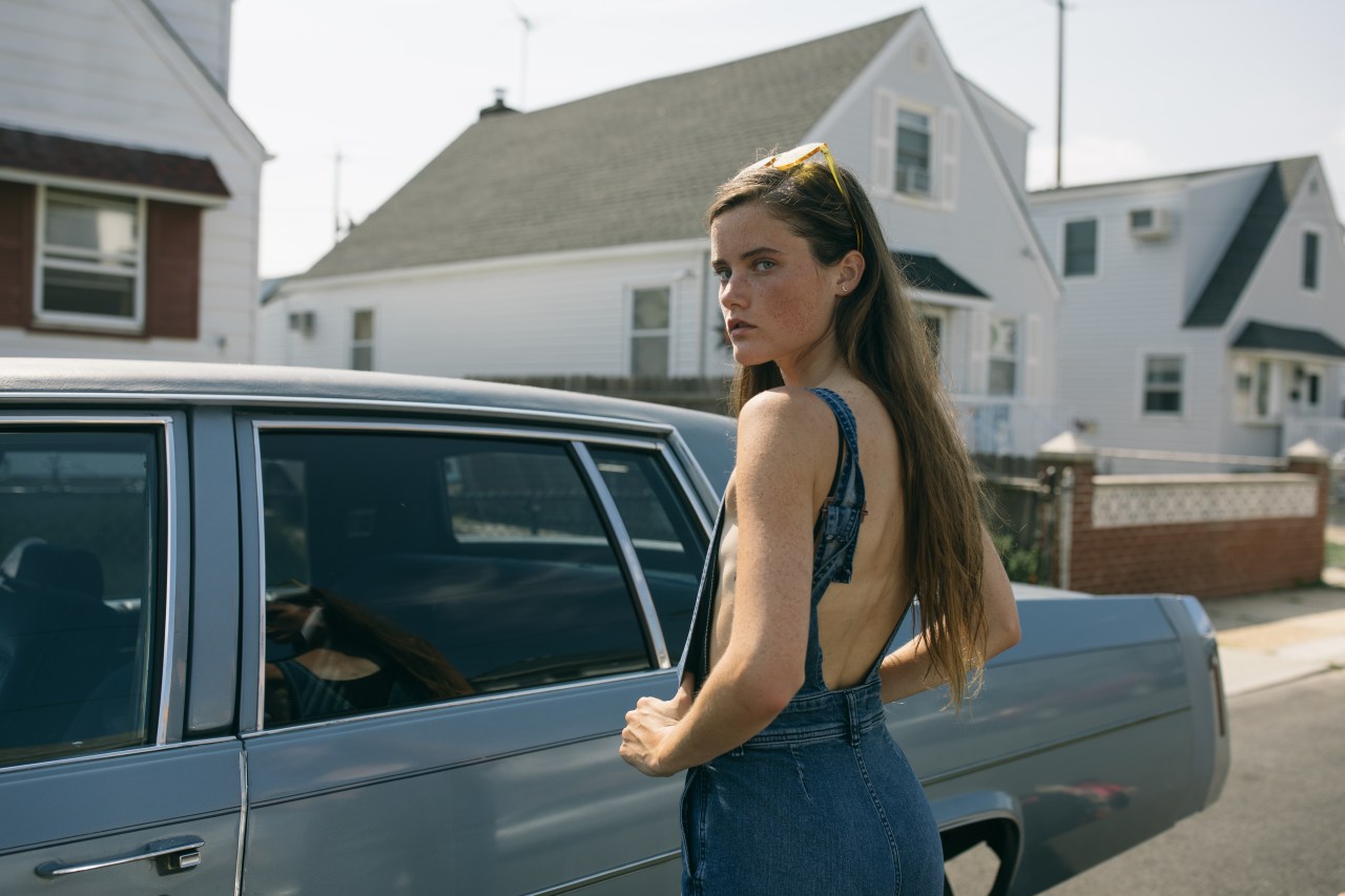 woman in bathing suit standing in front of car