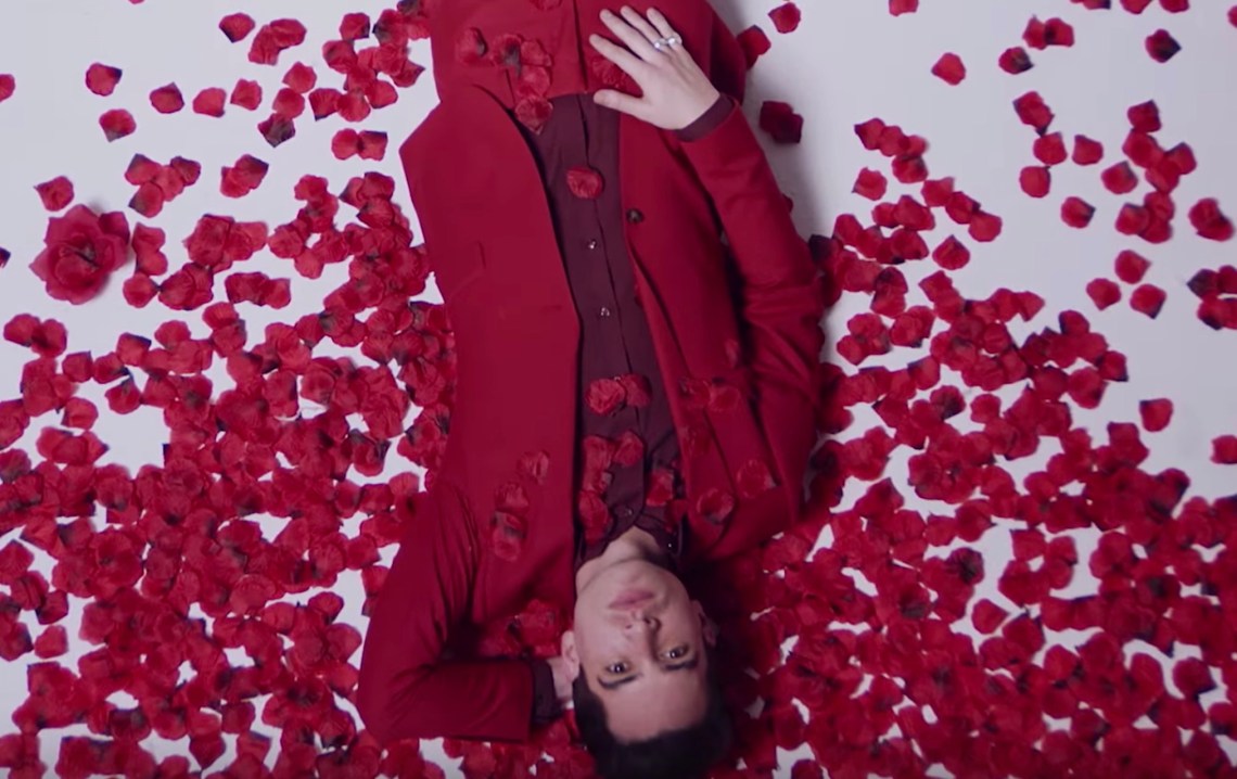 Brendan Urie surrounded by rose petals