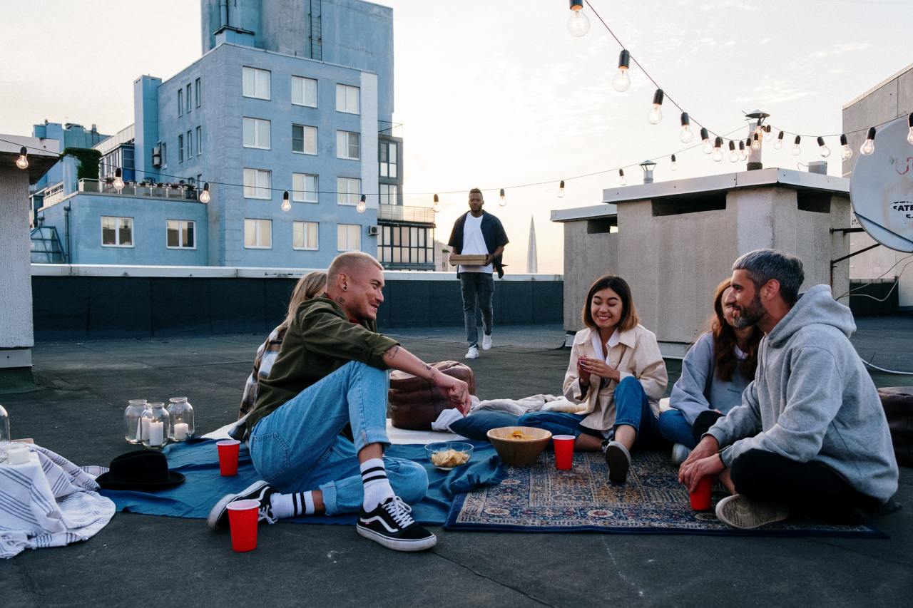 Man in Green Jacket Sitting Beside Woman in Blue Jacket