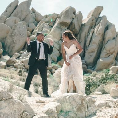 newly couple standing on rocks outside