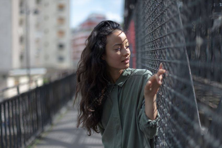 woman leaning on black chain link