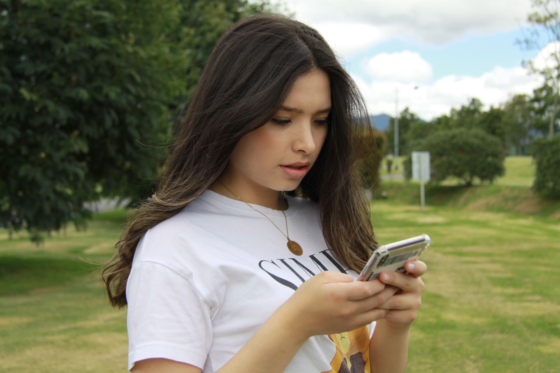 woman in white crew neck t-shirt holding silver iphone 6