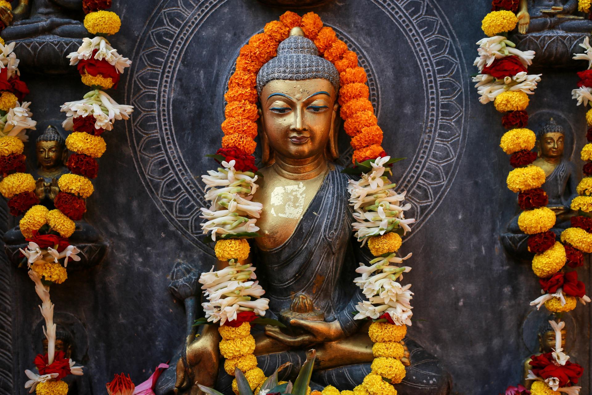 Buddha Surrounded With Flowers