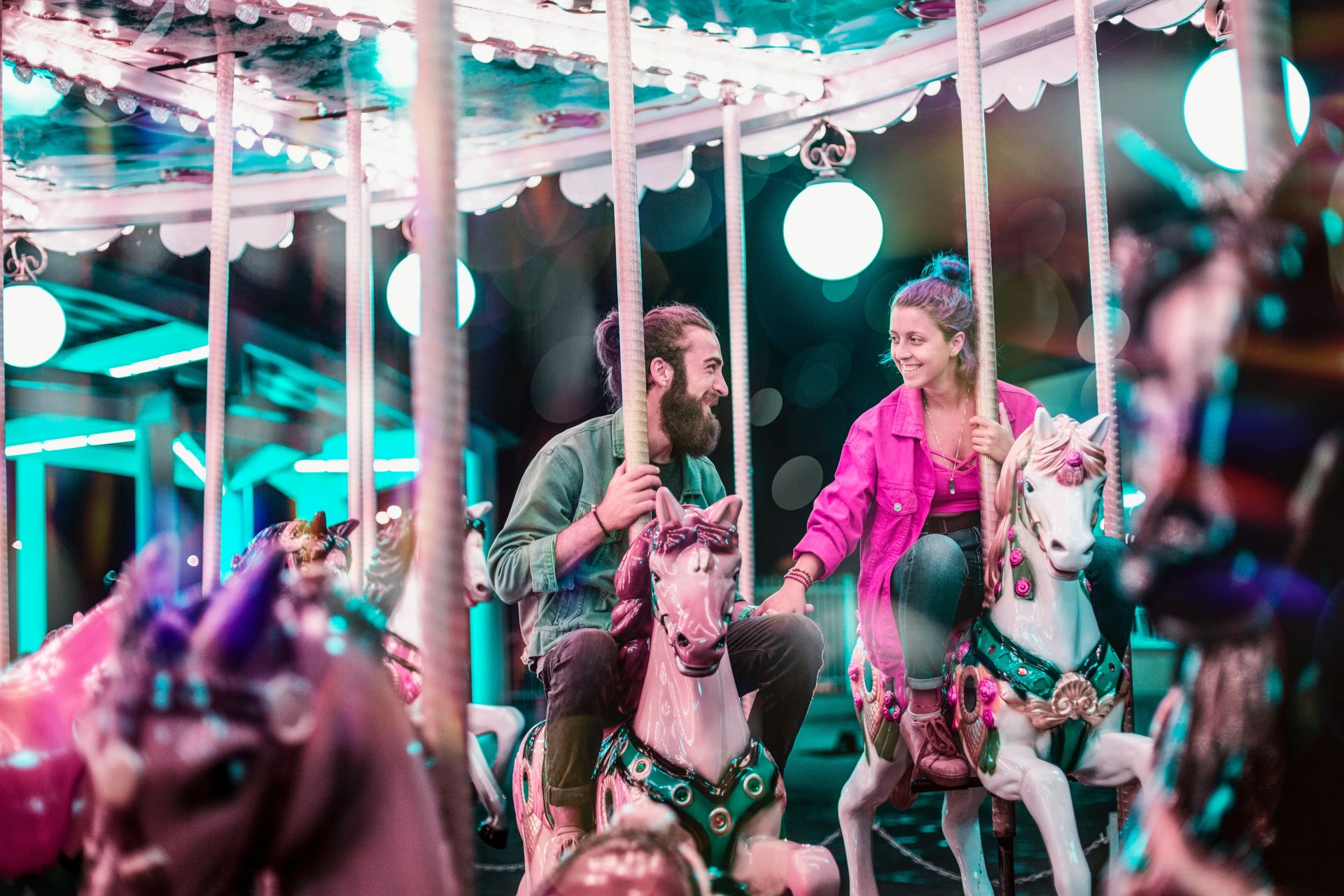 man and woman riding a carousel