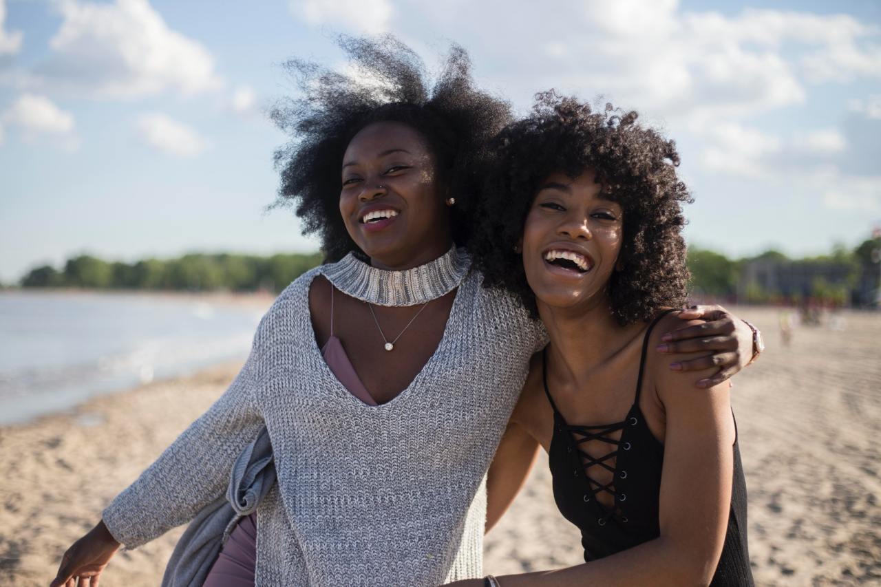 photo of woman beside another women at seashore