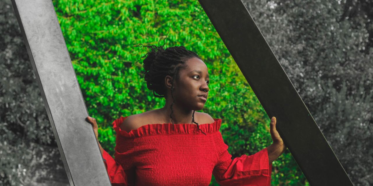 woman in red off-shoulder long-sleeved top holding posts