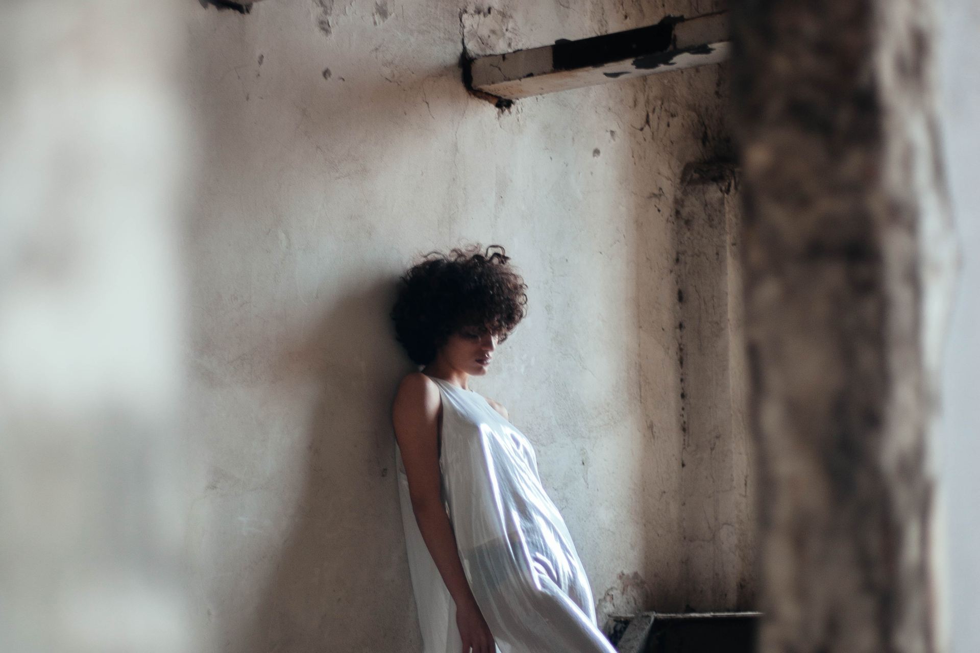 woman leaning on wall