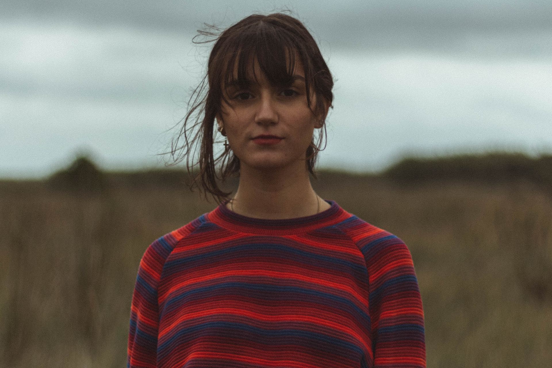 woman wearing blue and red striped crew-neck long-sleeved shirt