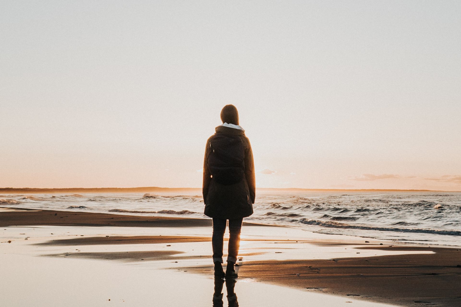 woman standing on sands near shoreline
