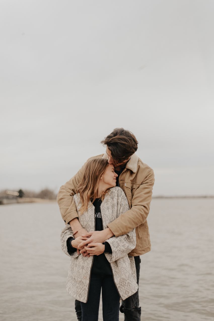 man hugging woman