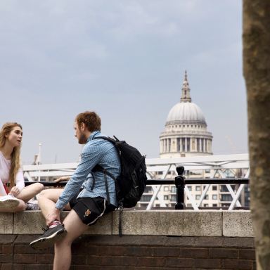 man and woman talking at the balcony