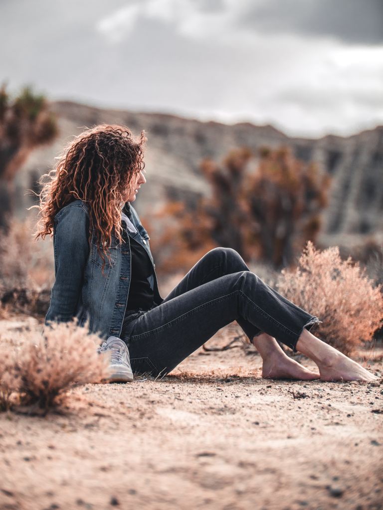 woman sitting on brown soil