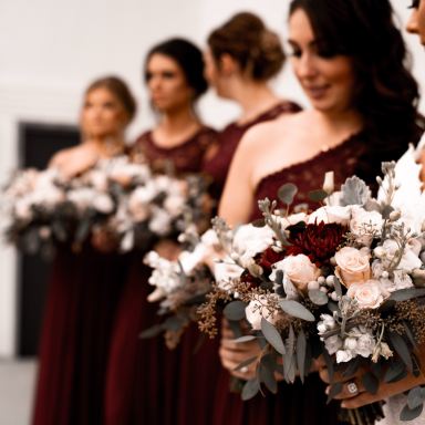 shallow focus photo of woman holding white flowers