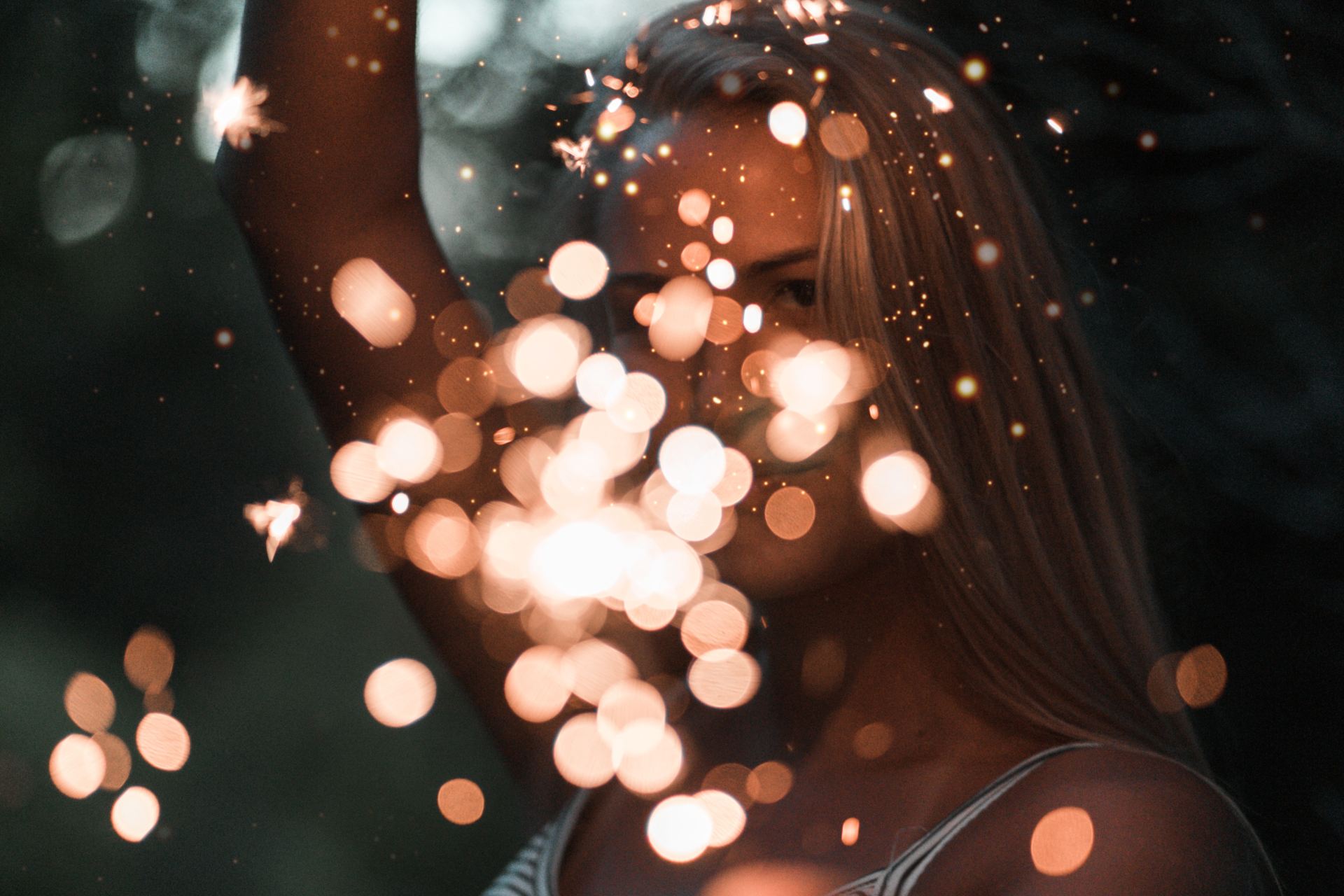 woman holding sparklers bokeh photography