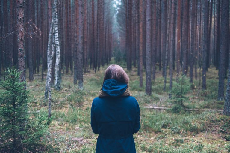 woman in hoodie at forest
