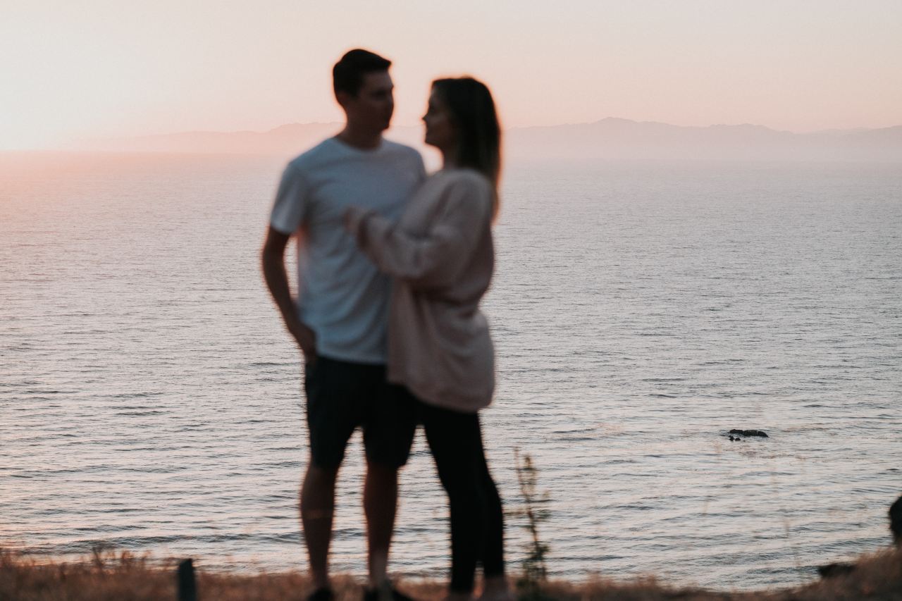 man and woman standing on sea dock during daytime