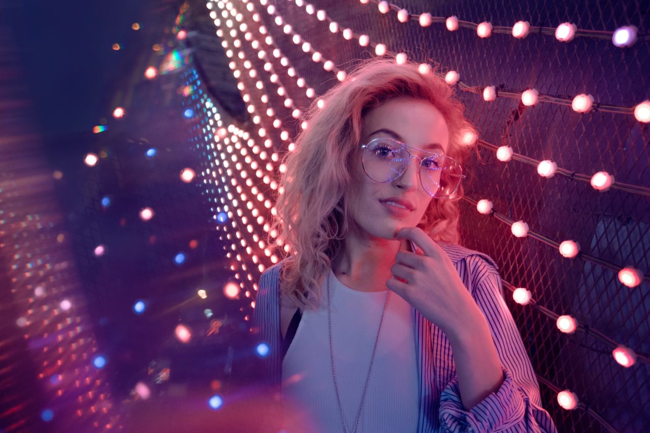 woman standing near string lights