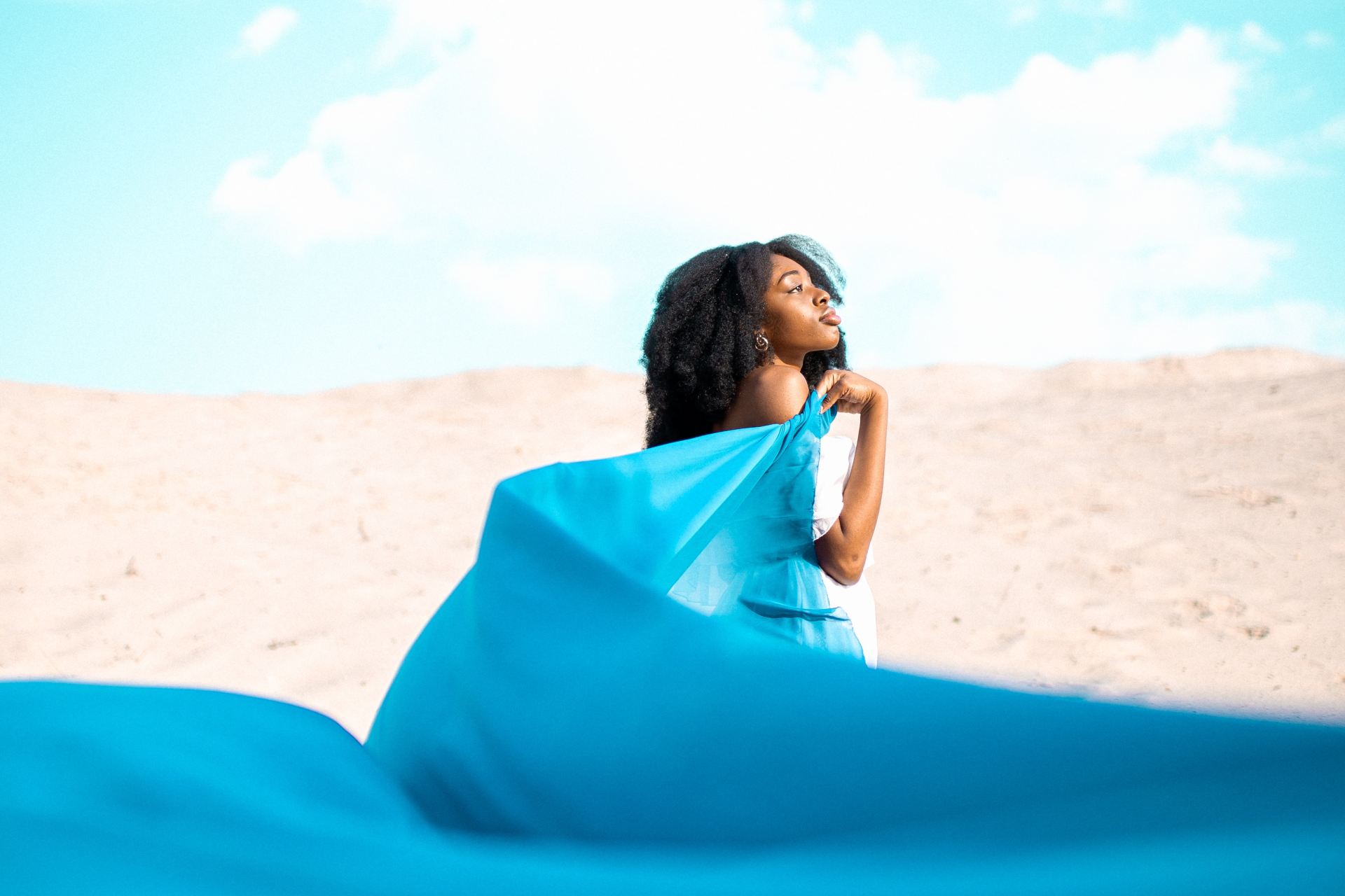 woman standing and holding floating dress