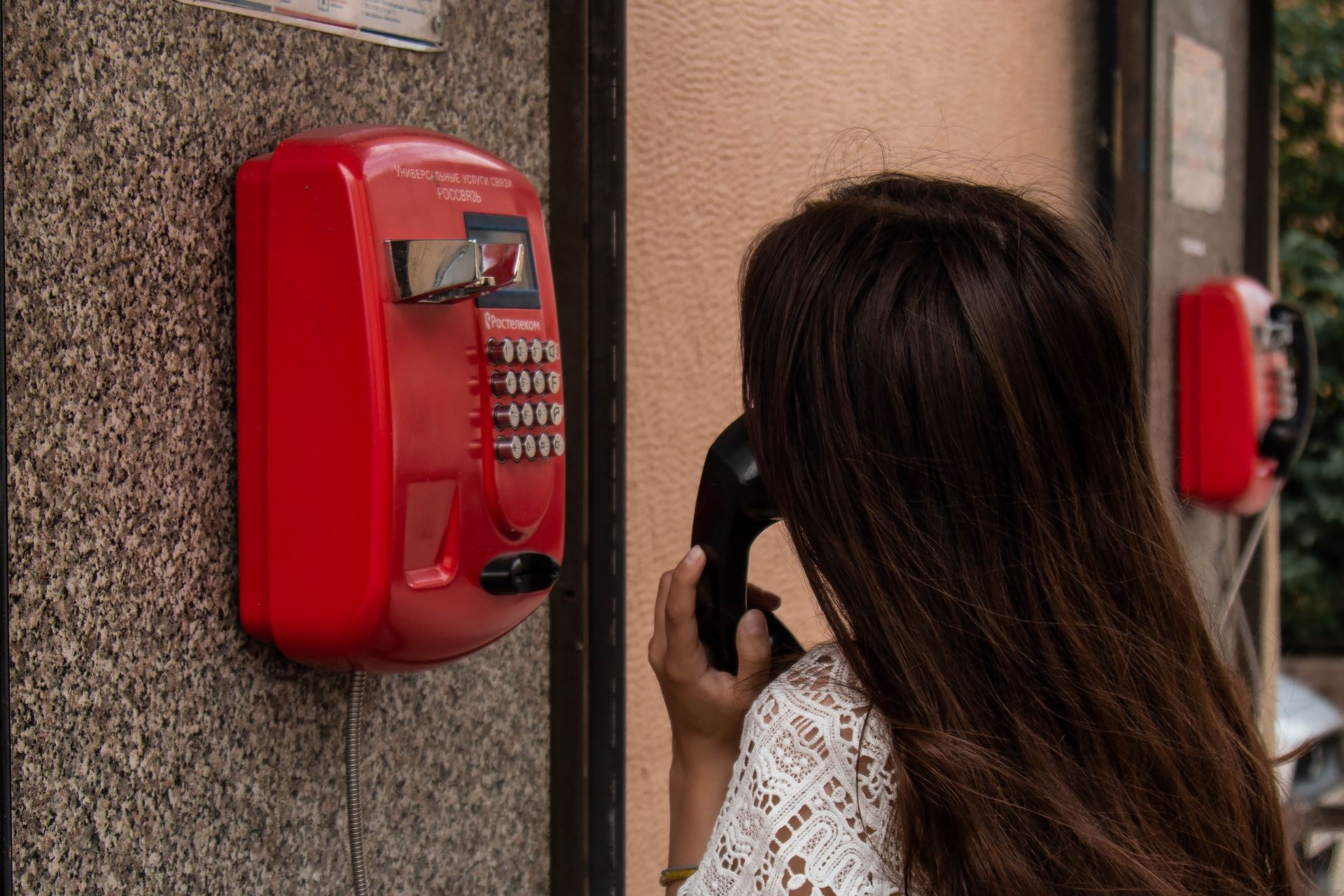 woman using payphone