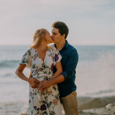 selective focus photography of couple on shoreline