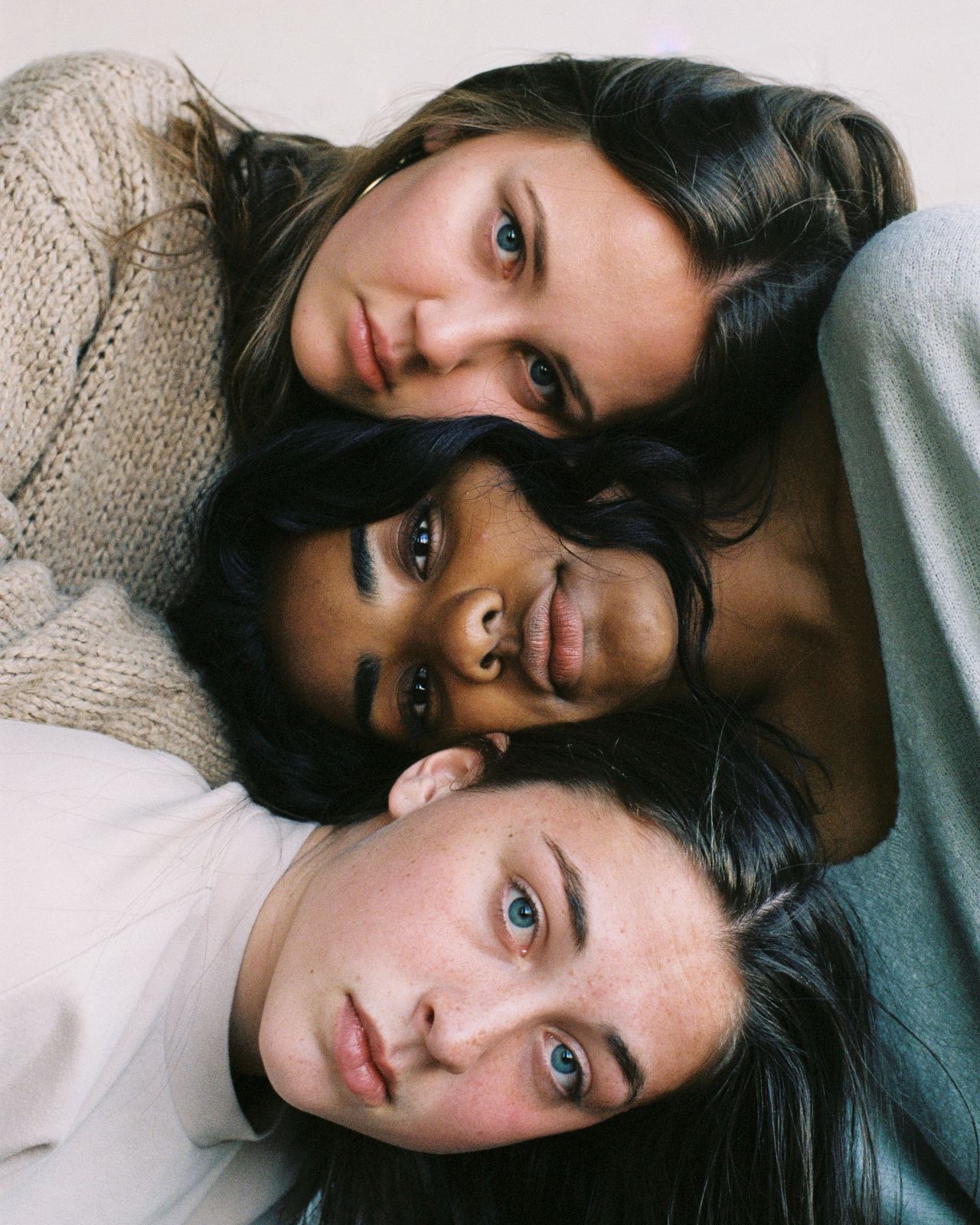 three women in assorted-color tops