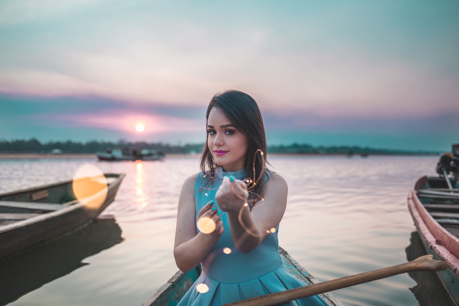 woman sitting on boat during sunset