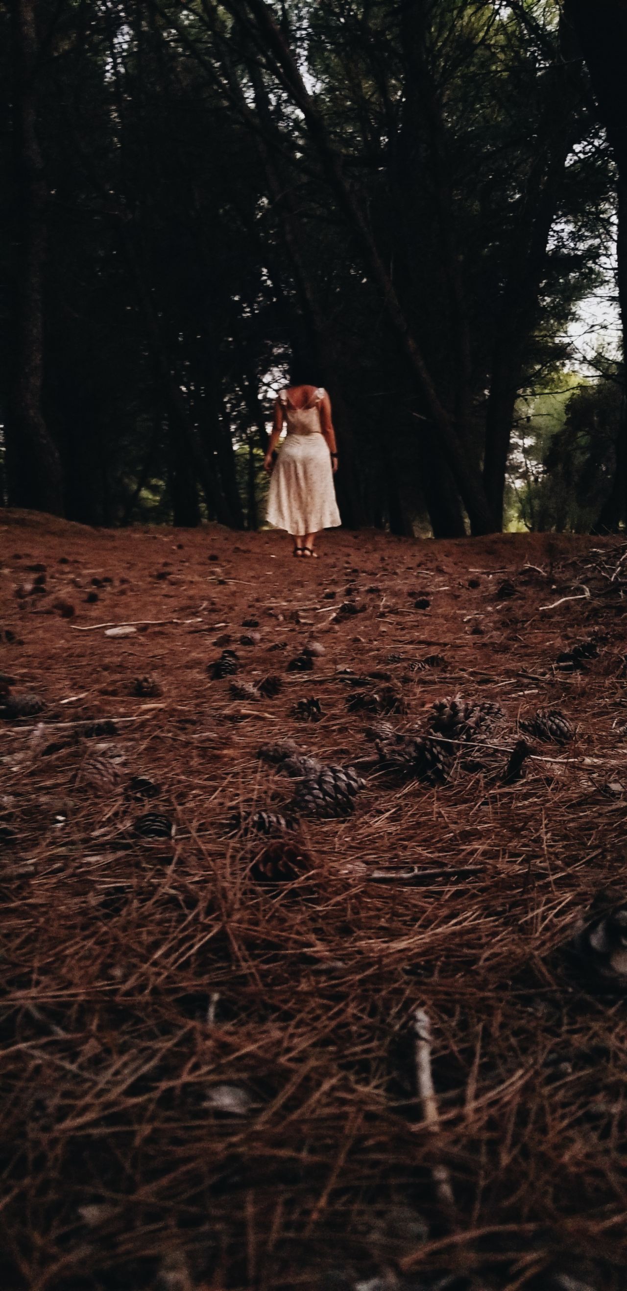 woman wearing white standing on brown soil