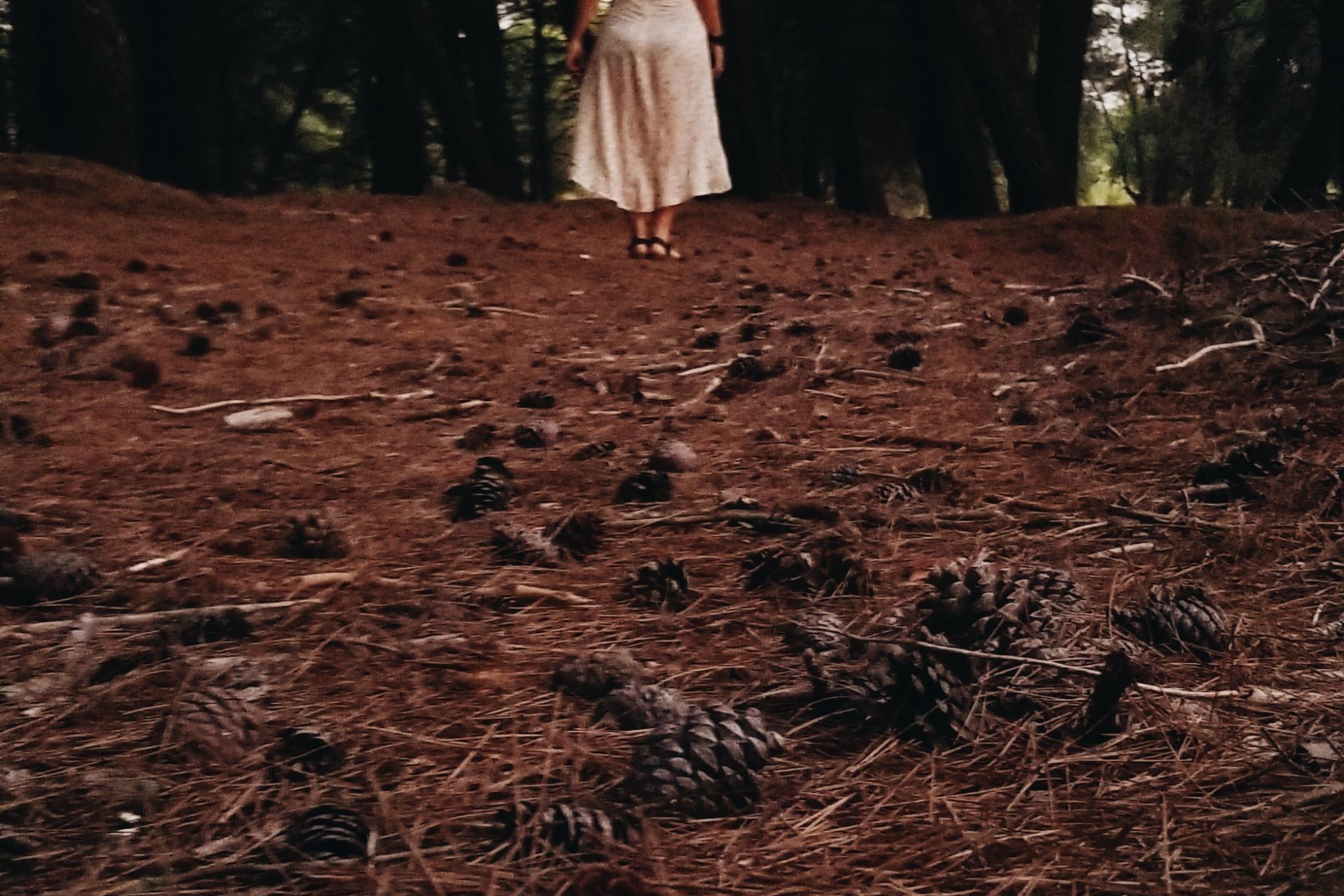 woman wearing white standing on brown soil