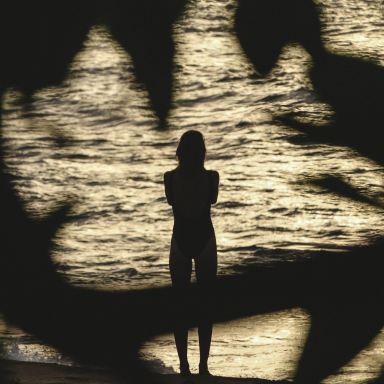 photo of person standing near body of water