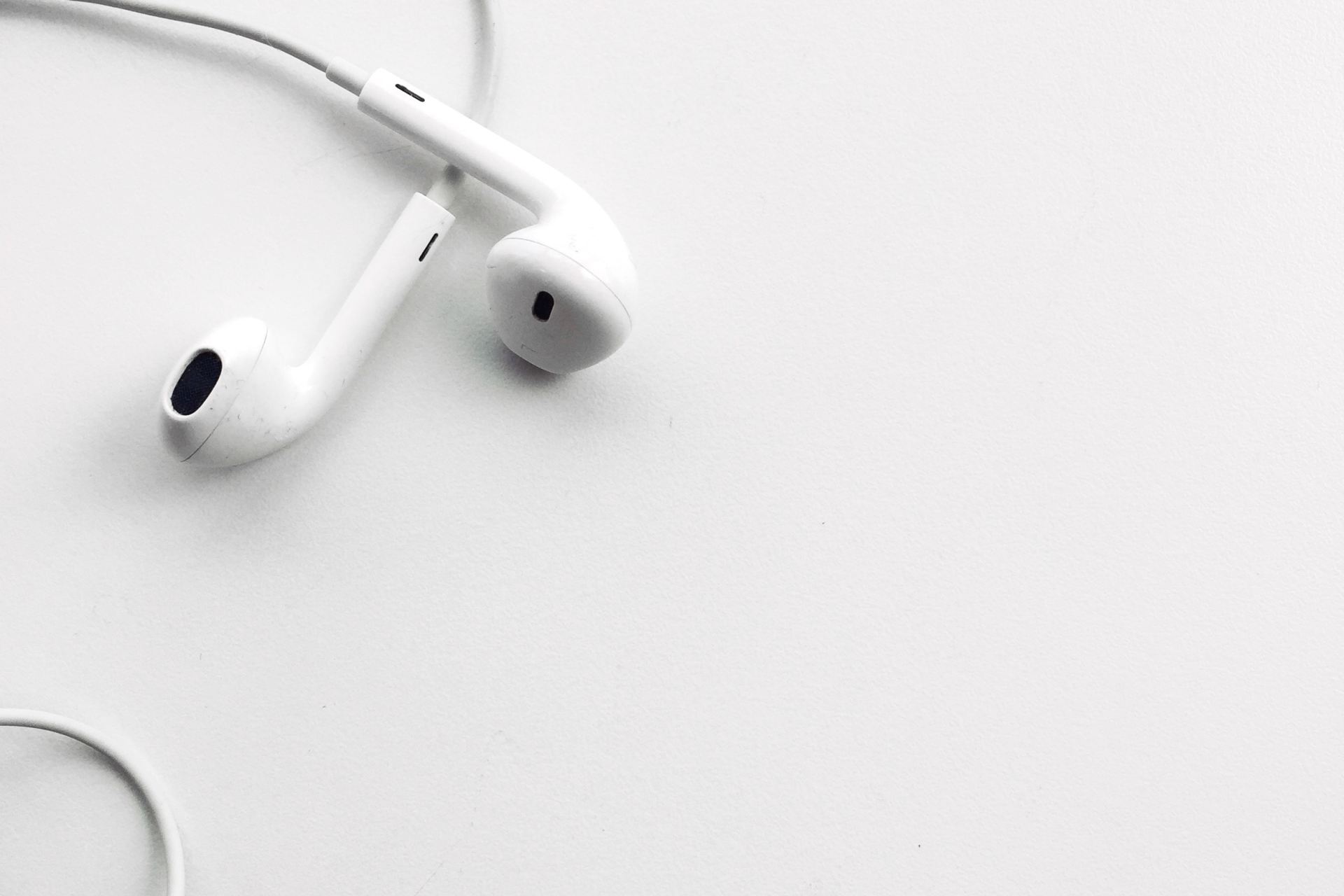 Apple AirPods on white surface