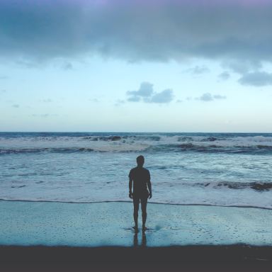 silhouette photography of man standing on seashore