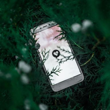 white smartphone on green grass