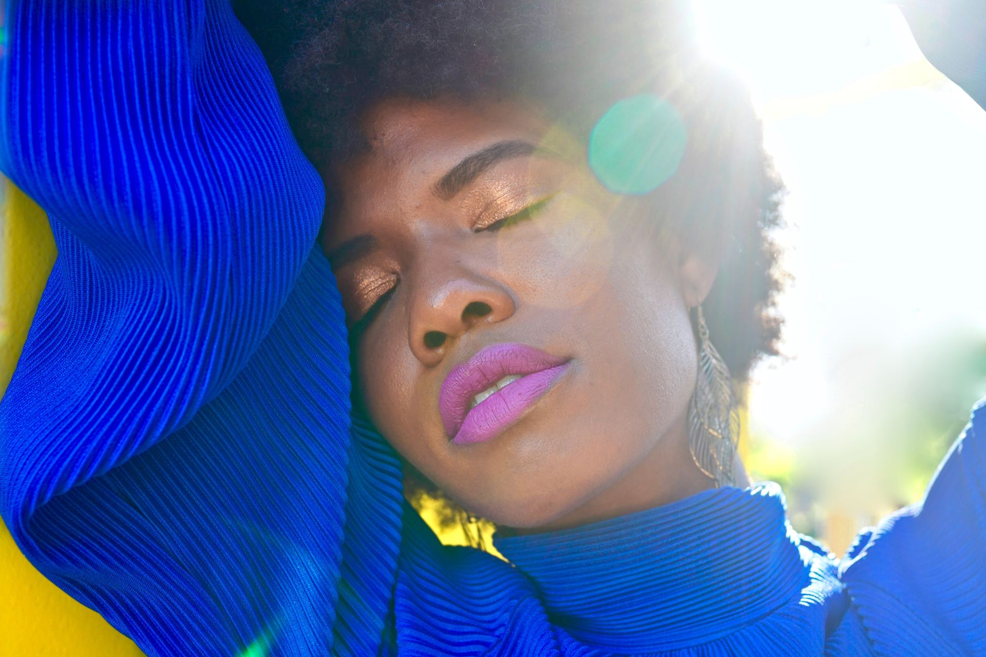 woman leans on yellow all