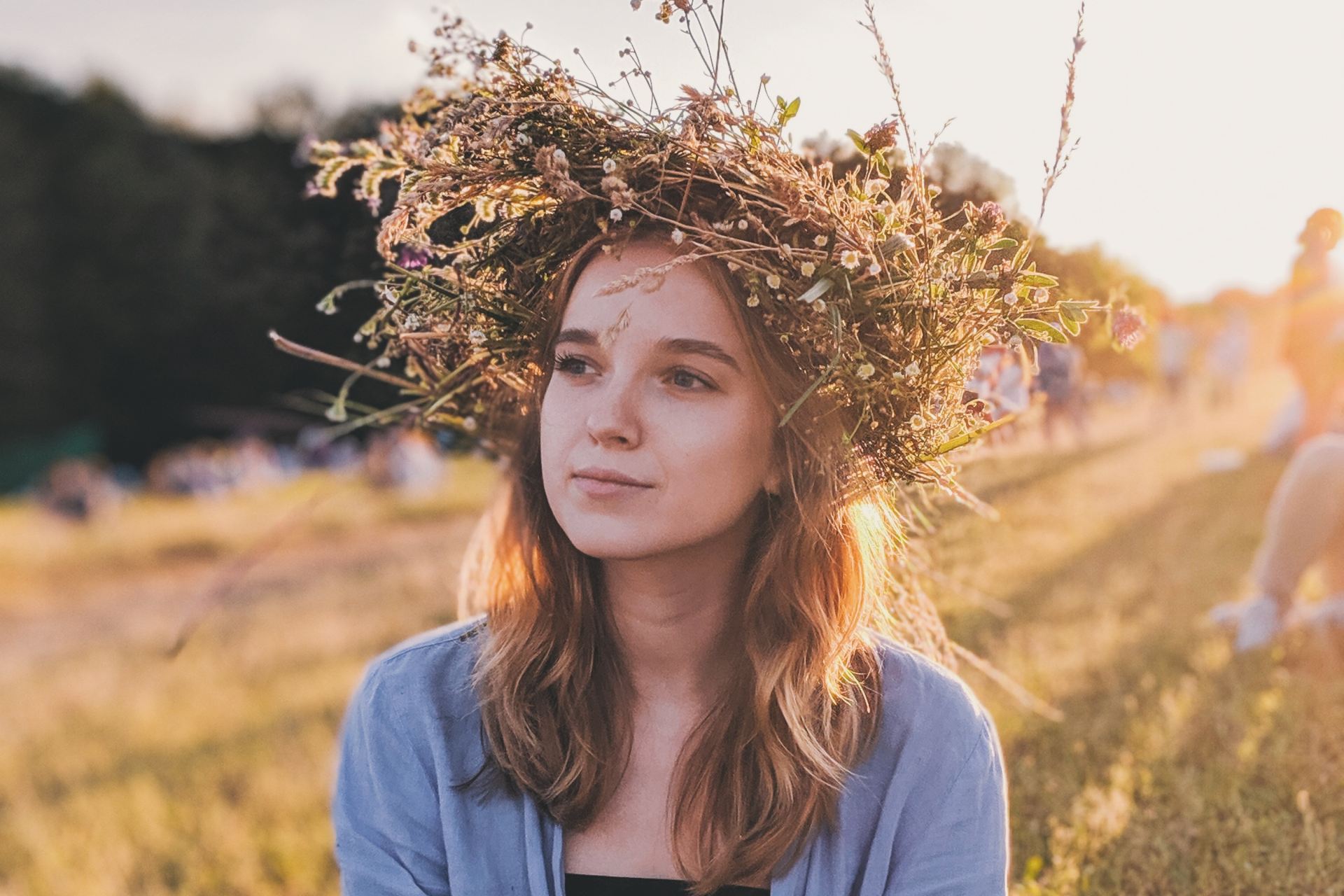 woman sitting down on grass